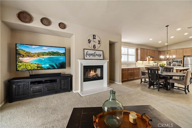 5058 Meadowsweet Dr, Palmdale, CA 93551 - living area featuring light carpet, a glass covered fireplace, baseboards, a chandelier, and recessed lighting