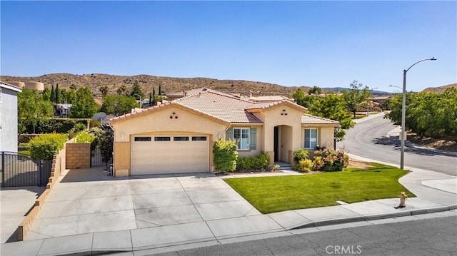 5058 Meadowsweet Dr, Palmdale, CA 93551 - mediterranean / spanish-style home featuring stucco siding, a garage, a gate, and a mountain view