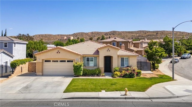 5058 Meadowsweet Dr, Palmdale, CA 93551 - mediterranean / spanish home featuring a mountain view, an attached garage, stucco siding, and a tile roof