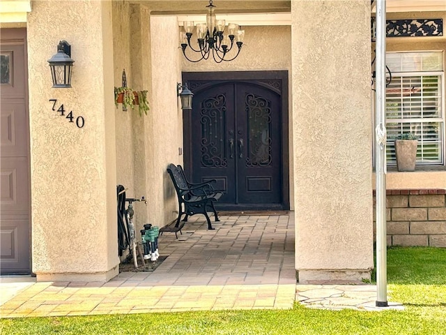 7440 Apple Blossom Ct, Highland, CA 92346 - property entrance featuring stucco siding and french doors