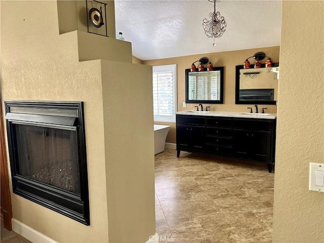 7440 Apple Blossom Ct, Highland, CA 92346 - full bath with a soaking tub, double vanity, a fireplace, a textured wall, and a textured ceiling