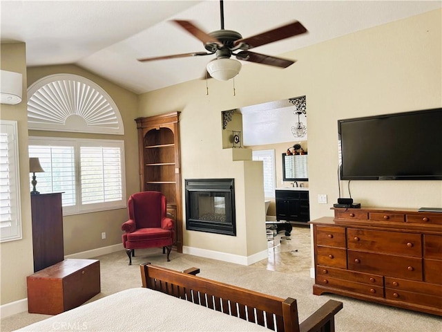 7440 Apple Blossom Ct, Highland, CA 92346 - bedroom featuring a multi sided fireplace, vaulted ceiling, baseboards, and light colored carpet