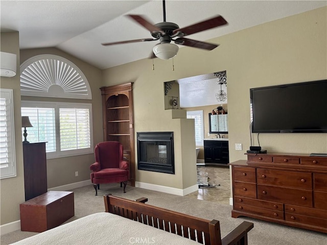 7440 Apple Blossom Ct, Highland, CA 92346 - bedroom featuring a multi sided fireplace, vaulted ceiling, baseboards, and carpet flooring