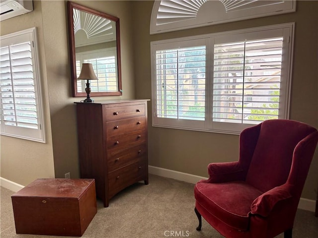 7440 Apple Blossom Ct, Highland, CA 92346 - living area featuring baseboards, light colored carpet, and an AC wall unit