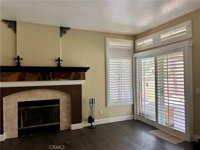 7440 Apple Blossom Ct, Highland, CA 92346 - unfurnished living room featuring wood finished floors, baseboards, a glass covered fireplace, and a textured ceiling