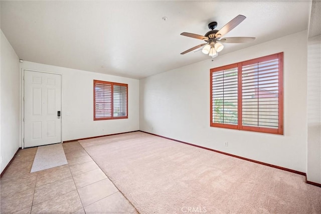 15863 Falcon Ct, Fontana, CA 92337 - spare room featuring ceiling fan, baseboards, light tile patterned floors, and light carpet