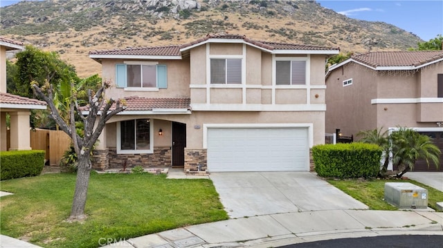 15863 Falcon Ct, Fontana, CA 92337 - view of front of property with stucco siding, a mountain view, an attached garage, a tiled roof, and concrete driveway