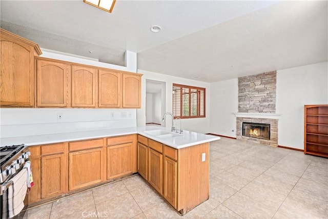 15863 Falcon Ct, Fontana, CA 92337 - kitchen with high end stainless steel range, a sink, a peninsula, light tile patterned floors, and light countertops