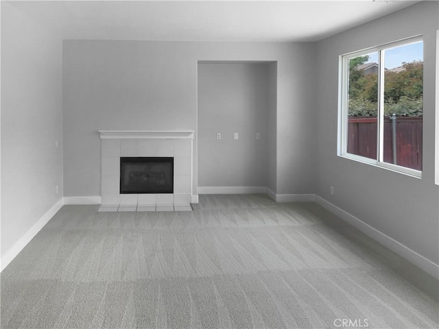 1281 Smoke Tree Ln, Beaumont, CA 92223 - unfurnished living room with carpet floors, a tiled fireplace, and baseboards
