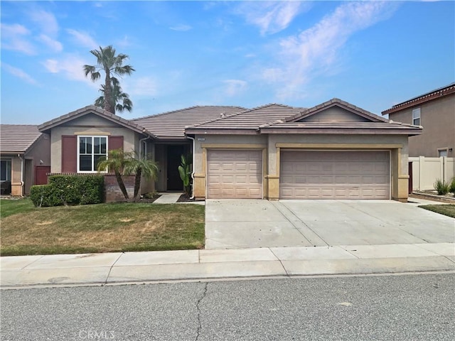 1281 Smoke Tree Ln, Beaumont, CA 92223 - single story home with a tile roof, an attached garage, concrete driveway, and stucco siding
