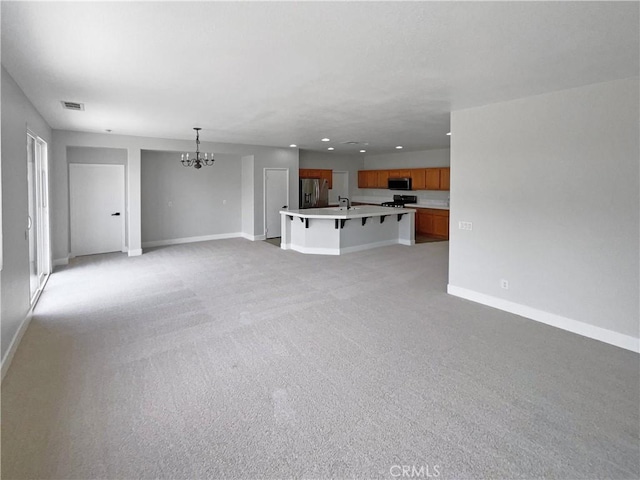 1281 Smoke Tree Ln, Beaumont, CA 92223 - unfurnished living room featuring a chandelier, baseboards, recessed lighting, light carpet, and a sink