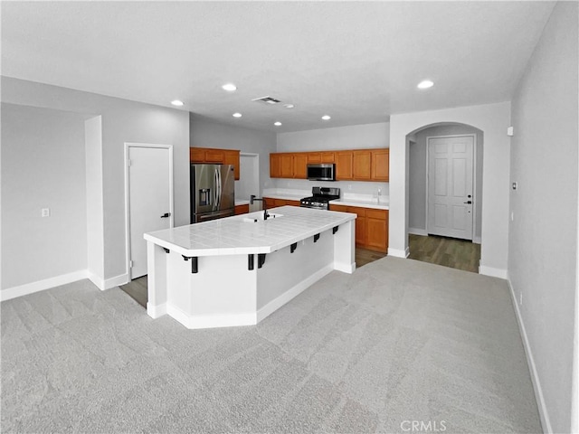 1281 Smoke Tree Ln, Beaumont, CA 92223 - kitchen with stainless steel appliances, light carpet, baseboards, recessed lighting, and light countertops