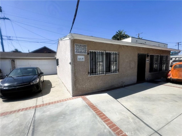 1022 W 103rd St, Los Angeles, CA 90044 - view of front of home with stucco siding and driveway
