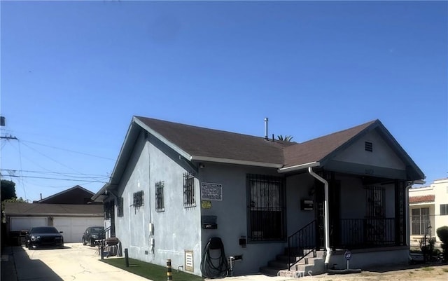 1022 W 103rd St, Los Angeles, CA 90044 - view of front of home with stucco siding and an outdoor structure