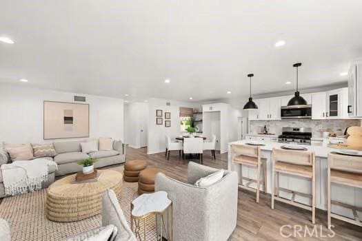 10946 Kentucky Ave, Whittier, CA 90603 - living room with light wood-style flooring and recessed lighting