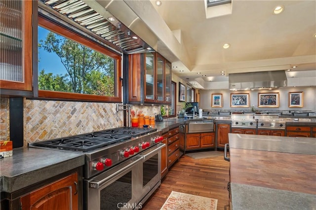 7626 E Saddlehill Trl, Orange, CA 92869 - kitchen featuring double oven range, glass insert cabinets, dark wood-type flooring, backsplash, and recessed lighting