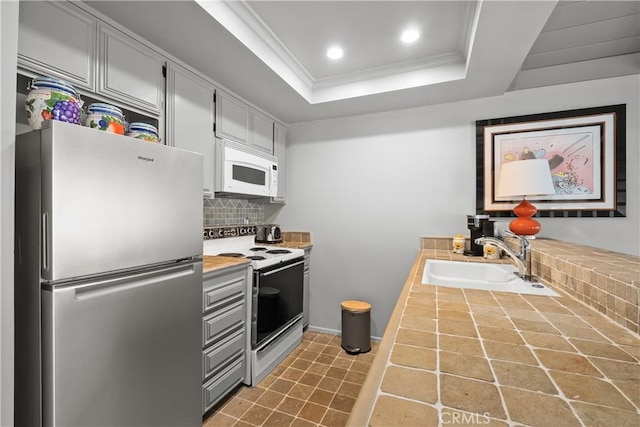 7626 E Saddlehill Trl, Orange, CA 92869 - kitchen with white appliances, a sink, backsplash, a raised ceiling, and ornamental molding