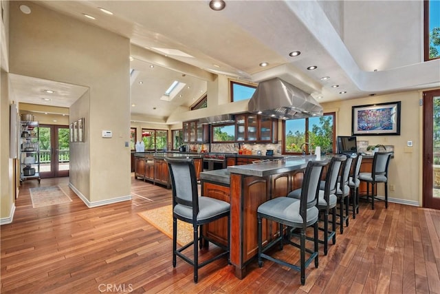 7626 E Saddlehill Trl, Orange, CA 92869 - bar area featuring baseboards, hardwood / wood-style floors, recessed lighting, high vaulted ceiling, and beam ceiling