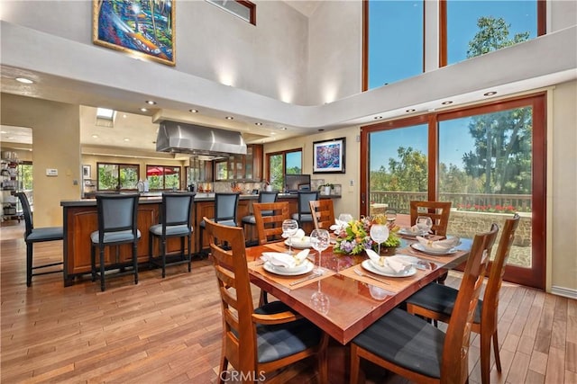 7626 E Saddlehill Trl, Orange, CA 92869 - dining space with light wood-style floors, a high ceiling, plenty of natural light, baseboards, and recessed lighting