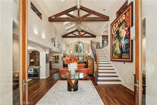 7626 E Saddlehill Trl, Orange, CA 92869 - entrance foyer featuring high vaulted ceiling, baseboards, hardwood / wood-style floors, beamed ceiling, and stairs