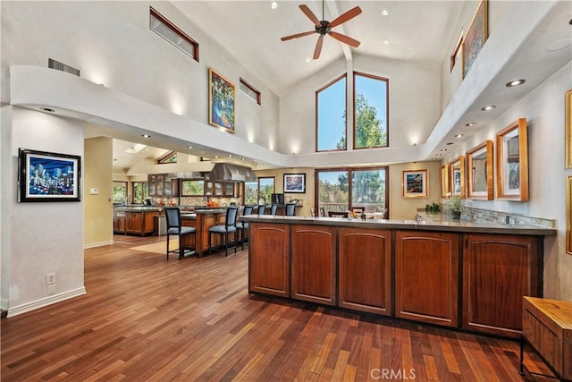 7626 E Saddlehill Trl, Orange, CA 92869 - bar area featuring dark wood-style floors, a ceiling fan, high vaulted ceiling, and healthy amount of natural light