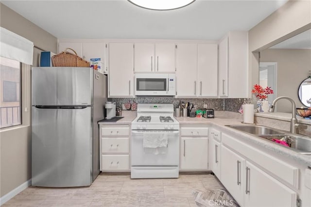 1140 Pacific Ave Unit 10, Long Beach, CA 90813 - kitchen featuring white appliances, a sink, white cabinetry, and light countertops