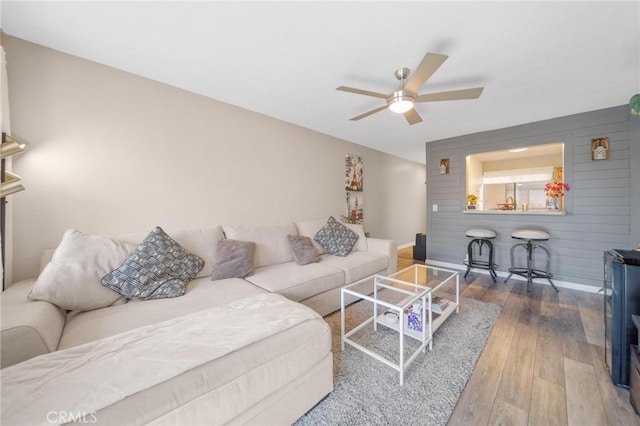 1140 Pacific Ave Unit 10, Long Beach, CA 90813 - living room featuring hardwood / wood-style flooring, ceiling fan, baseboards, and wood walls