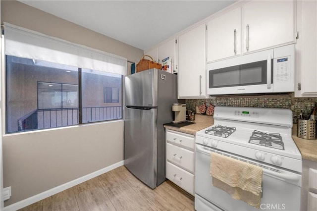1140 Pacific Ave Unit 10, Long Beach, CA 90813 - kitchen with white appliances, tasteful backsplash, light wood-type flooring, and white cabinetry