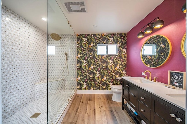 6324 E Colorado St, Long Beach, CA 90803 - bathroom featuring wallpapered walls, walk in shower, wood finished floors, double vanity, and toilet