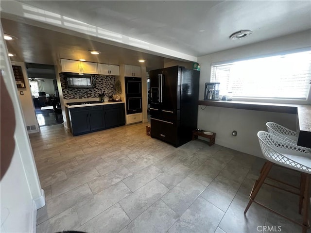 1767 W Chandeleur Dr, San Pedro, CA 90732 - kitchen with black appliances, backsplash, light countertops, and dark cabinetry
