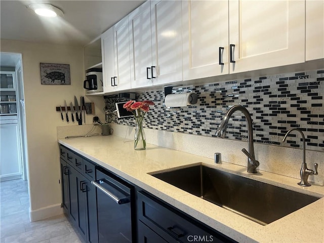 1767 W Chandeleur Dr, San Pedro, CA 90732 - kitchen with a sink, white cabinets, light stone countertops, decorative backsplash, and stainless steel microwave