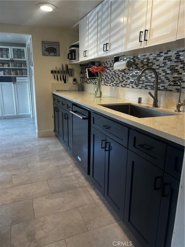 1767 W Chandeleur Dr, San Pedro, CA 90732 - kitchen featuring a sink, dishwashing machine, tasteful backsplash, and white cabinets
