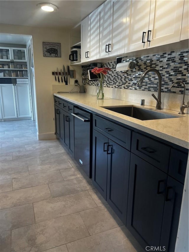 1767 W Chandeleur Dr, San Pedro, CA 90732 - kitchen with tasteful backsplash, white cabinetry, light stone counters, and black dishwasher