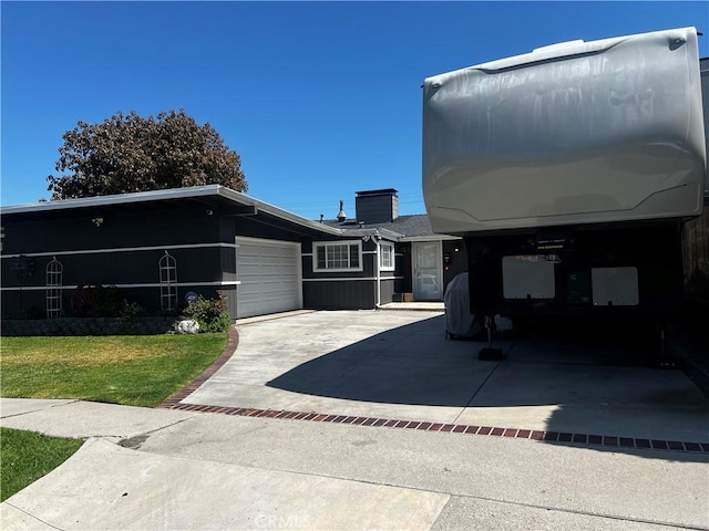 1767 W Chandeleur Dr, San Pedro, CA 90732 - view of property exterior featuring a garage, driveway, a chimney, and a lawn