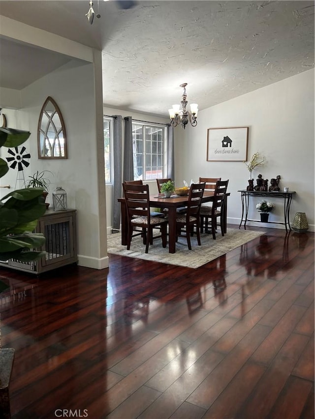 1767 W Chandeleur Dr, San Pedro, CA 90732 - dining space featuring wood finished floors, a chandelier, baseboards, and a textured ceiling