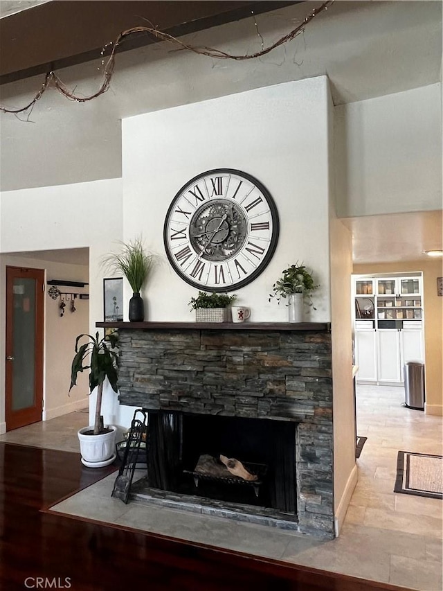 1767 W Chandeleur Dr, San Pedro, CA 90732 - detailed view of a stone fireplace, wood finished floors, and baseboards