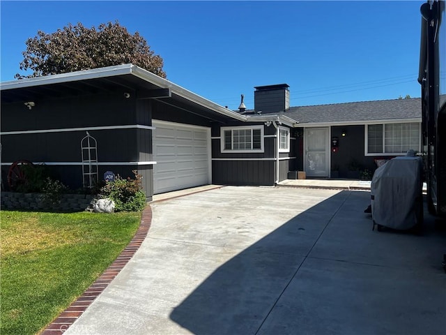 1767 W Chandeleur Dr, San Pedro, CA 90732 - rear view of property featuring an attached garage, a lawn, a chimney, and driveway