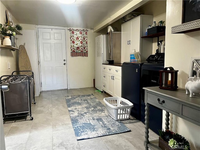 1767 W Chandeleur Dr, San Pedro, CA 90732 - kitchen with open shelves, white cabinetry, washer and dryer, dark countertops, and freestanding refrigerator