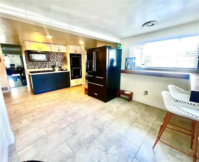 1767 W Chandeleur Dr, San Pedro, CA 90732 - kitchen with black appliances, decorative backsplash, light countertops, and white cabinetry