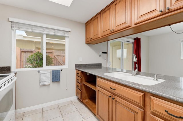 7879 Rancho Fanita Unit A, Santee, CA 92071 - kitchen with electric stove, a sink, light tile patterned flooring, baseboards, and brown cabinetry
