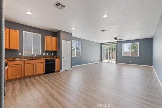 1171 S Filbert Ave, Fresno, CA 93727 - kitchen featuring black dishwasher, a ceiling fan, light wood-style flooring, open floor plan, and baseboards
