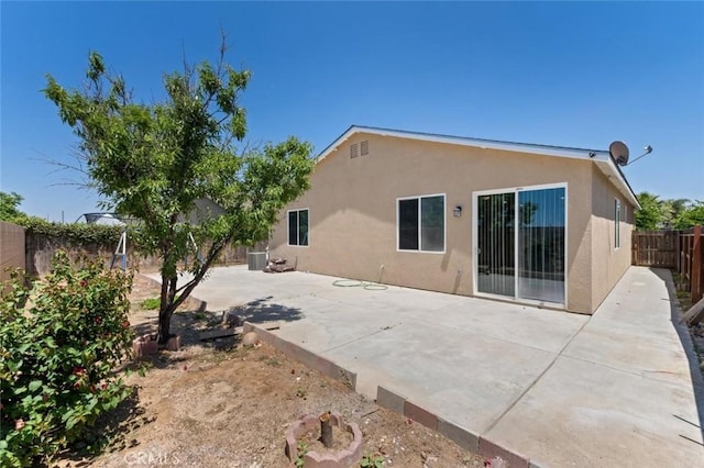 1171 S Filbert Ave, Fresno, CA 93727 - rear view of house featuring stucco siding, a fenced backyard, and a patio area