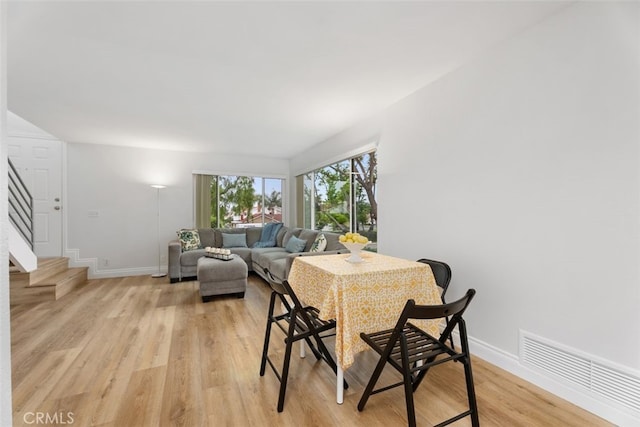 24462 Copper Cliff Ct Unit 20, Lake Forest, CA 92630 - dining room featuring light wood-type flooring, baseboards, and stairway