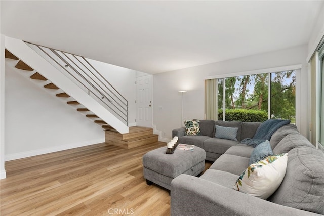 24462 Copper Cliff Ct Unit 20, Lake Forest, CA 92630 - living room with light wood-style floors, baseboards, and stairway