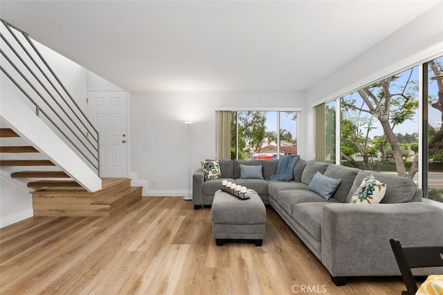24462 Copper Cliff Ct Unit 20, Lake Forest, CA 92630 - living area featuring stairs, baseboards, and light wood-style floors