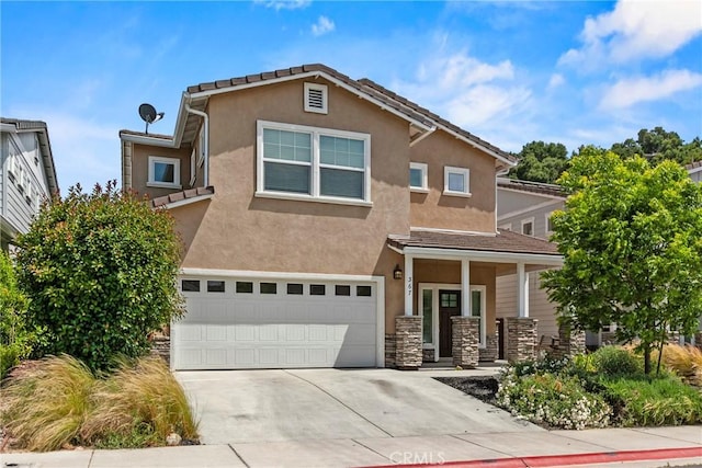 367 Lily Pad Ln, Templeton, CA 93465 - view of front of house with an attached garage, concrete driveway, stucco siding, a porch, and stone siding