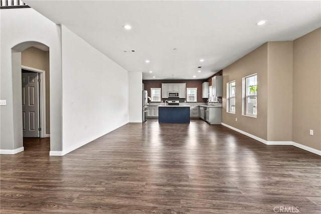 367 Lily Pad Ln, Templeton, CA 93465 - unfurnished living room featuring dark wood finished floors, recessed lighting, and arched walkways