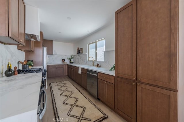 1709 Wollacott St, Redondo Beach, CA 90278 - kitchen with stainless steel appliances, tasteful backsplash, light stone countertops, under cabinet range hood, and light wood finished floors