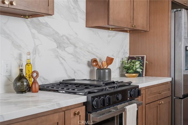 1709 Wollacott St, Redondo Beach, CA 90278 - kitchen with gas stove, freestanding refrigerator, tasteful backsplash, and brown cabinets