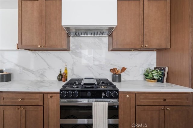1709 Wollacott St, Redondo Beach, CA 90278 - kitchen featuring stainless steel gas range oven, custom range hood, tasteful backsplash, and brown cabinetry